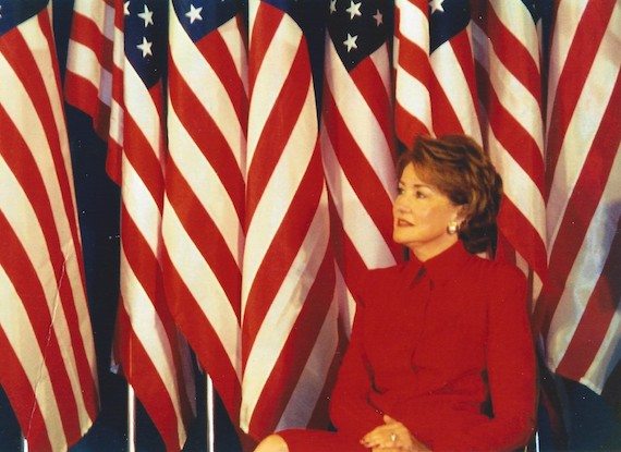 Vintage Photo of Elizabeth Dole in front of American flags